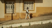 a man on a skateboard is walking down a street