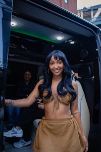 a woman standing in the back of a limo