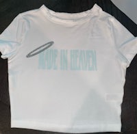 a white t - shirt that says made in heaven