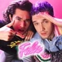 two men posing in front of a pink background