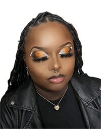 a woman with orange eye makeup and dreadlocks