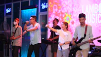 a group of people singing on stage at a nightclub