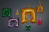 a group of colorful foil balloons hanging on a wall