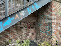 graffiti on the steps of a brick building