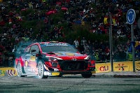 hyundai ioniq rally car on a track in front of a crowd