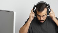 a man wearing headphones in front of a computer