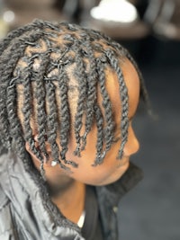 a young girl with braids in her hair