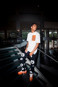 a young man standing on stairs in a building
