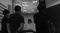 a group of people standing in front of a projector