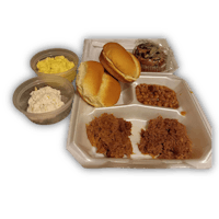 a tray with a sandwich, eggs, biscuits and gravy