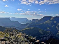 the view from the top of a mountain overlooking a valley