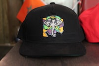 a black hat with an elephant on it