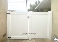 a white gate with a black handle on it