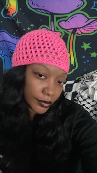a woman wearing a pink crocheted hat