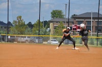 two softball players playing a game of softball