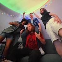 a group of people posing for a photo in a living room