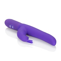 a purple vibrating toy lying on a white surface