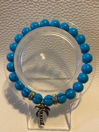 a bracelet with turquoise beads on it