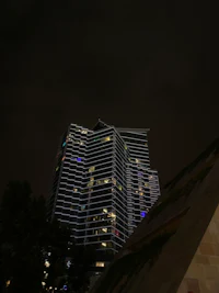 a tall building is lit up at night