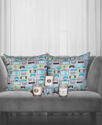 a couch with pillows and a candle in front of it