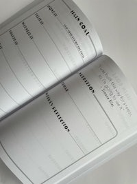 a notebook with a blank page and writing on it