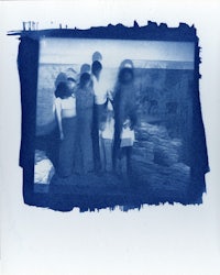 a photo of a group of people standing in front of a blue background