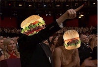 a man in a tuxedo and a woman in a tuxedo holding a burger