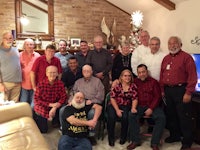 a group of people posing for a picture in a living room