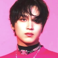 a young man in a pink shirt with a necklace