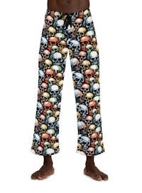 a black man wearing a skull print pajama pants