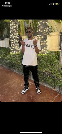 a man is posing for a picture on his phone