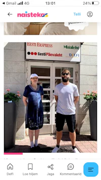 a man and a woman standing in front of a building