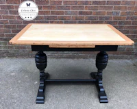 a table with a black top and wooden legs
