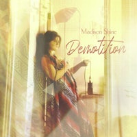 a woman in a dress is leaning against a door