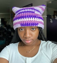 a woman wearing a crocheted cat hat