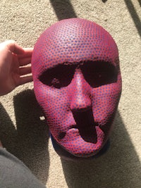 a person is holding a red and blue polka dot head
