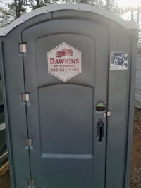 a gray portable toilet with the word damon's on it