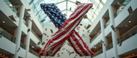 two american flags hanging from the ceiling of a building