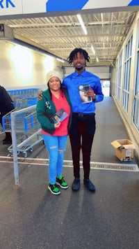 two people standing next to each other in a grocery store
