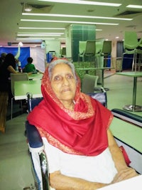 an old woman sitting in a hospital waiting room