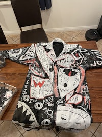 a black and white jacket with a shark on it