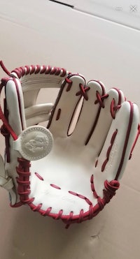 a baseball glove with red and white stitching