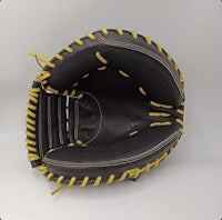 a black and yellow catcher's mitt on a white background