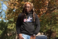 a man with dreadlocks wearing a hoodie