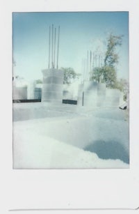 a polaroid of a building with a lot of snow on it