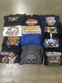 lots of harley davidson t - shirts