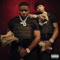 two men holding money in front of a red background
