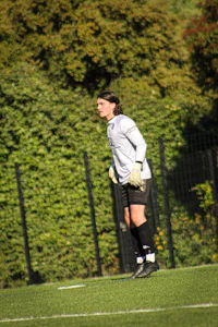 a woman is standing on a soccer field