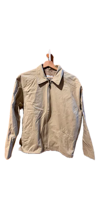 a tan jacket hanging on a hanger