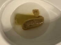 a toilet bowl with a piece of bread in it